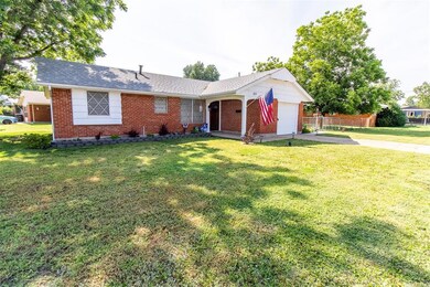 Ranch-style house featuring a garage and a front l