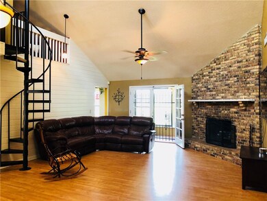 Great room with spiral staircase to loft