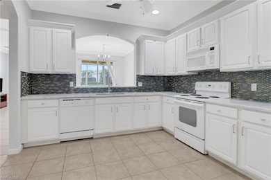 Kitchen featuring white appliances, a sink, white 
