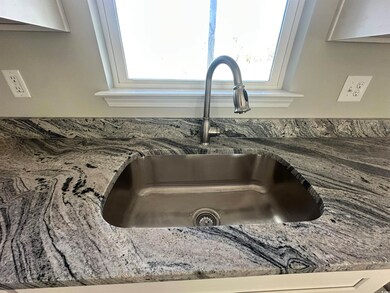 Featuring White Himalaya granite countertops and f