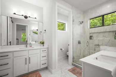 Bathroom featuring marble look tile flooring, van