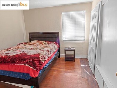Bedroom featuring dark wood-type flooring and a closet