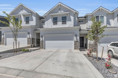 View of front facade featuring concrete driveway, stone siding, and a garage