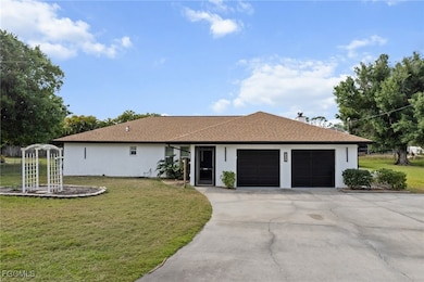 Ranch-style home featuring stucco siding, an attac