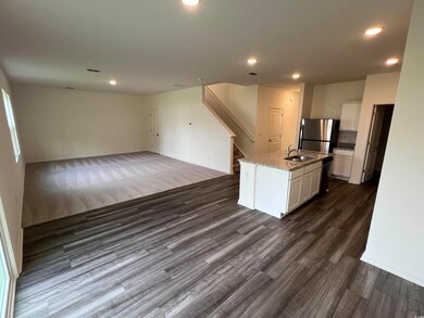 Kitchen featuring light stone countertops, sink, d