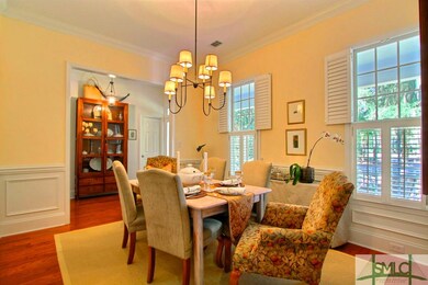 Freshly painted dining room featuring wainscoting,