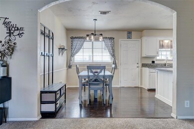 Carpeted dining room with a notable chandelier and