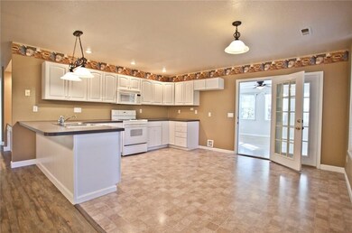 The kitchen connects to the bonus room, so taking food and drinks to friends is easy!