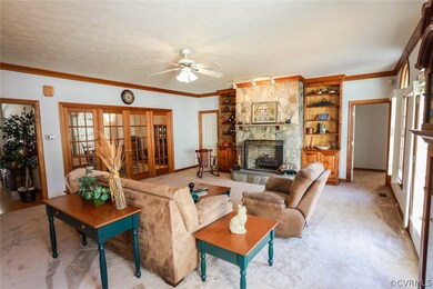 BRIGHT OPEN FAMILY ROOM WITH GORGEOUS STONE FIREPLACE, BUILT-INS AND CROWN MOLDING!