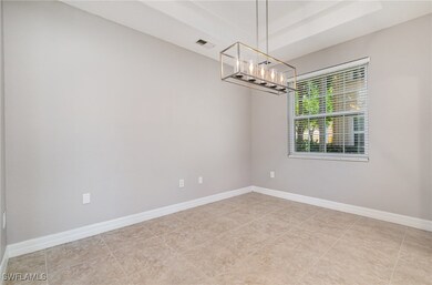 Spare room with a chandelier, visible vents, a tra