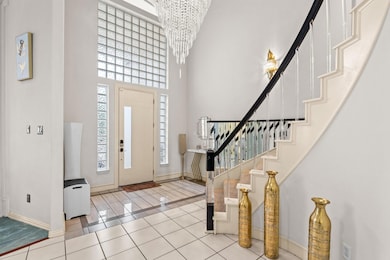 Entryway with light tile patterned flooring, stair