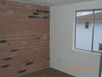 One of the bedrooms with brick accent