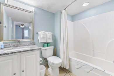 Full bathroom featuring toilet, vanity, tile patte