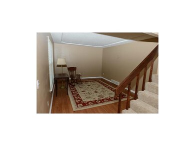 Living room with laminate floors and beveled ceili