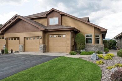 Craftsman inspired home with stone siding, asphalt driveway, central air condition unit, and a shingled roof