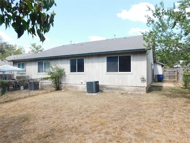Rear view of house featuring a shingled roof