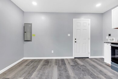 Kitchen with electric panel, wood finished floors,