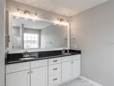 Master bath with updated hardware and gorgeous mirror.  In the mirror you can see the full layout of the bathroom.  The window in the mirror is above the bath.