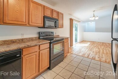 Kitchen opens into dining space with sliding doors onto the side porch.