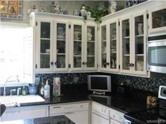 Kitchen cabinets with granite slab.