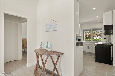 Hall with recessed lighting, baseboards, and a sin
