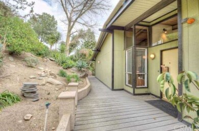 Front of house with deck to stairs and inviting an