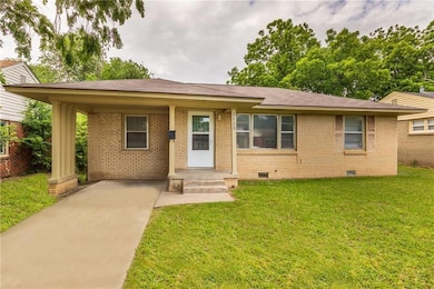 View of front of home featuring crawl space, brick siding, driveway, and a front yard
