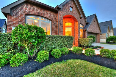 Fresh mulch and meticulously maintained lawn complement the all red brick exterior.