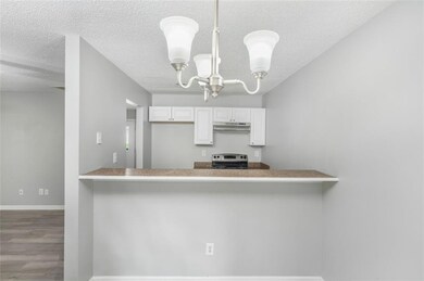Dining space with a chandelier (Virtually Staged)