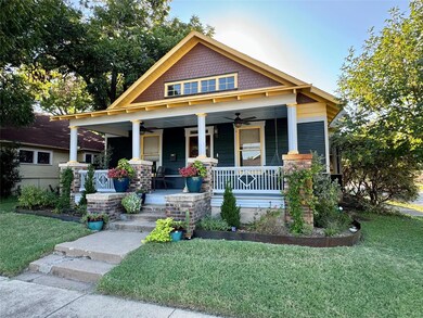 Craftsman-style home with a front lawn and covered