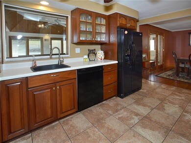 This view of the kitchen looks into the formal dining room, as well as through the window to the family room.