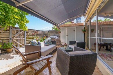 Fully fenced, private patio with retractable awnin