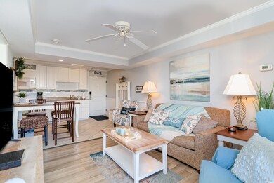 Living room featuring a ceiling fan, ornamental mo