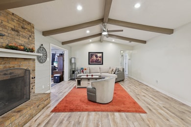 Living area featuring a brick fireplace, wood finished floors, recessed lighting, and ceiling fan