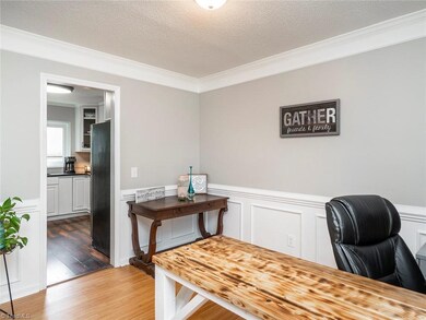 Formal dining room with beautiful crown molding and wainscoting.