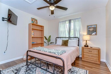 The guest bedroom features a queen size bed and a 32