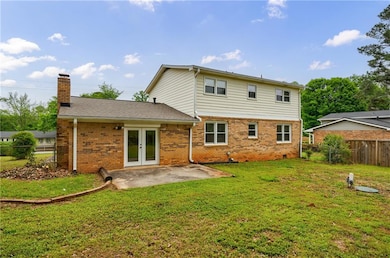 Back of property with a patio, a fenced backyard, 