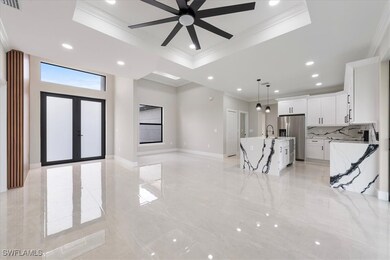 Unfurnished living room with a tray ceiling, ornam