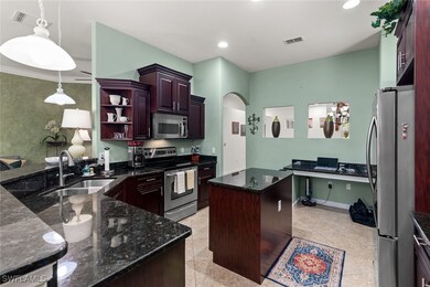 Kitchen featuring visible vents, arched walkways,