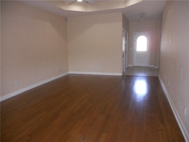Great room looking back toward foyer has trayed ce