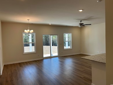Unfurnished living room featuring baseboards, plen