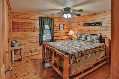 Bedroom featuring wood-type flooring, a textured c