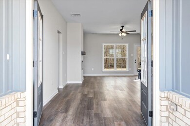 Hallway with dark hardwood / wood-style flooring