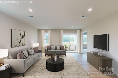 Spacious open floor plan featuring a sunlight great room with large window and sliding door that flood the space with natural light.