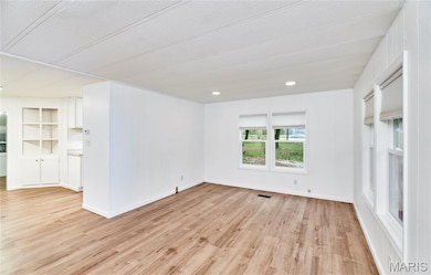 Spare room with light wood-type flooring and recessed lighting