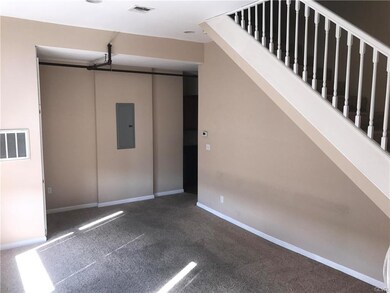 Living room toward kitchen, and stairs.