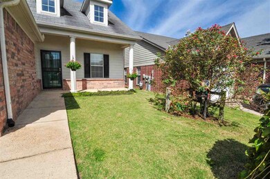 Guests are greeted by a covered porch and a wrough