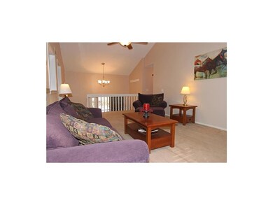 Open Living Room with Cathedral Ceilings and Fan