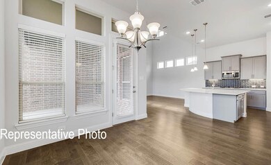 Kitchen featuring a kitchen island with sink, an i