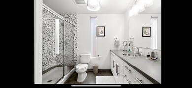 Bathroom with vanity, baseboards, a stall shower,